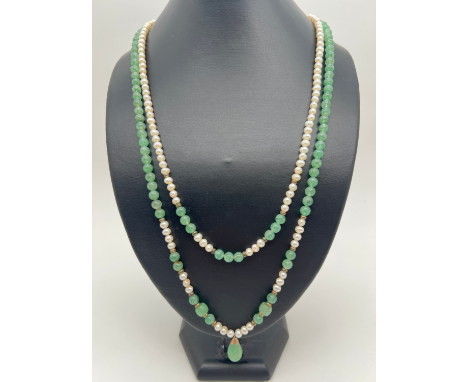 A double row pearl and green jade bead necklace with jade drop, gold tone metal spacer beads and push clasp. Total length inc