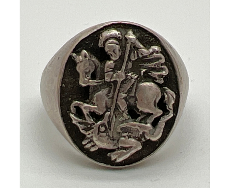 A vintage 800 silver signet ring with St. George and dragon decoration. Marked to inside of band. Size R, total weight approx