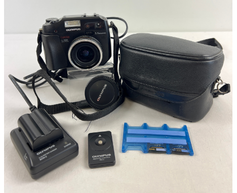 An Olympus Camedia C-5060 5.1 Megapixel Wide Zoom lens camera with neck strap, carry case, 3 x memory cards, battery, charger