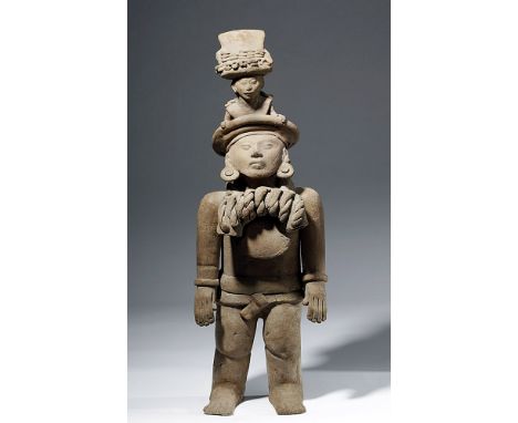 Pre-Columbian, Gulf Coast of Mexico, Veracruz culture, ca. 500 to 700 CE. An amazing, tall, hollow, buff ceramic figure with 