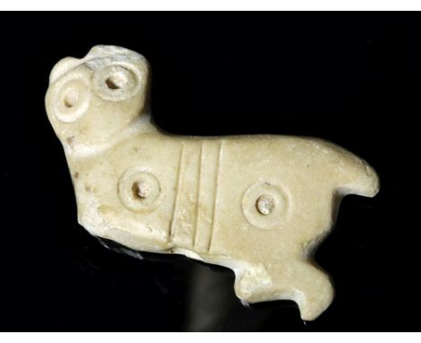 Ancient Near East, Mesopotamia, Sumeria, ca. 2500 to 2200 BCE. A smooth calcite amulet of a feline, posed dynamically as if c