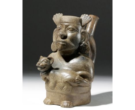 Pre-Columbian, North Coast Peru, Moche III, ca. 400 CE. A burnished blackware/brownware vessel depicting a seated man with a 