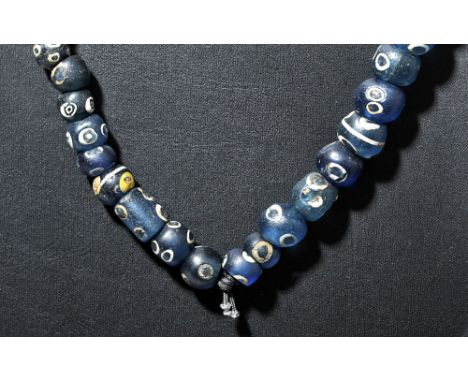 Roman, ca. 1st to 3rd century CE, possibly earlier. A lovely strand of seventy one translucent glass beads, each with multipl