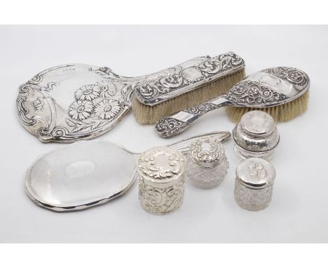 A group of early 20th Century dressing table silver to include: two brushes, a table mirror, two glass bottles and two furthe