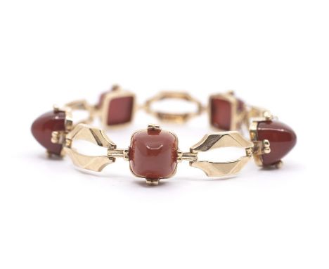 An Art Deco carnelian and 9ct gold bracelet, comprising alternate claw set sugar loaf carnelian stones and geometric open gol