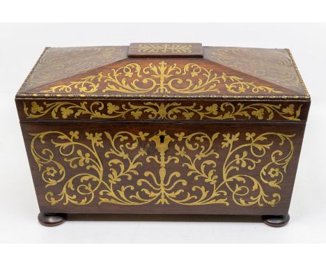 An early 19th Century rosewood and brass inlaid large sarcophagus tea caddy, fitted interior, brass handles, on four bun feet
