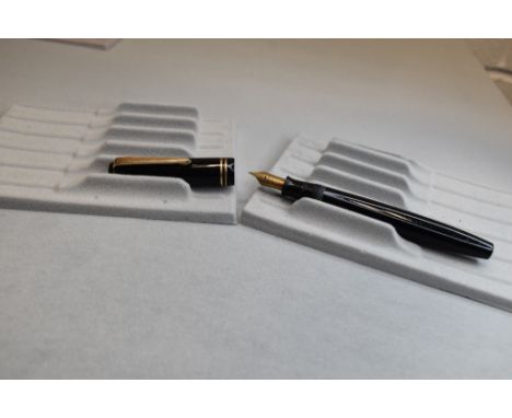 A Parker Victory button fill fountain pen in black with two narrow bands to the cap having a Parker N nib. Approx 13.1cm