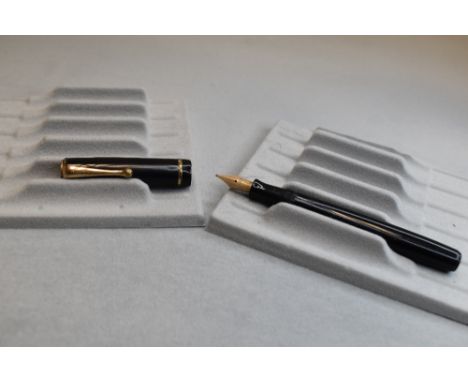 A Parker Moderne button fill fountain pen in black with single band to cap having Parker 14k nib . Approx 11.4cm (Engraved)