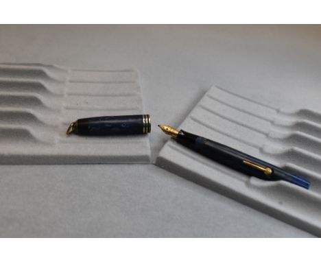 A Burnham leverfill fountain pen in blue with three narrow bands to cap and ring having Burnham 14k nib. Approx 10.2cm