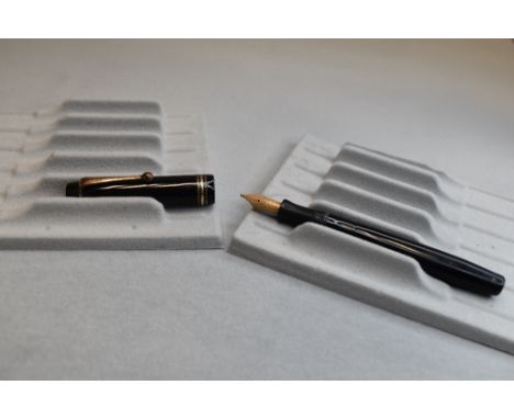A Parker Duofold button fill fountain pen in black with one braod and two narrow bands to the cap having a Parker Duofold N n