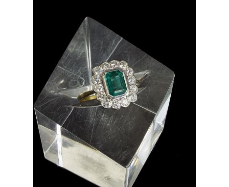 18ct emerald and diamond rectangular cluster ring, the central emerald 1.2ct approx, within a surround of round brilliant cut