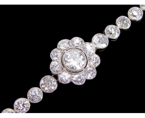 Fine platinum diamond bracelet, the centre daisy cluster with a single round cut diamond of 1ct approx, with a surround of ni