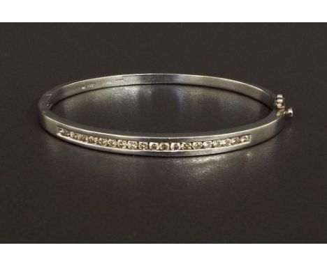 White gold diamond set bangle, channel set with round brilliant cut diamonds, 1ct approx, colour L/M, SI, stamped 9k, 14.3gm
