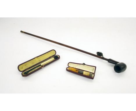 Collection of smoking items to include long wooden pipe, cigarette holder and one other (3)