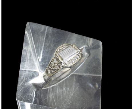 14k white gold diamond set dress ring, with a baguette-cut diamond within a surround of pave set round-cut diamonds, 0.90ct a