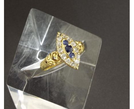 Old cut diamond and sapphire marquise shape cluster ring, with three sapphires in a surround of twelve diamonds in a yellow g