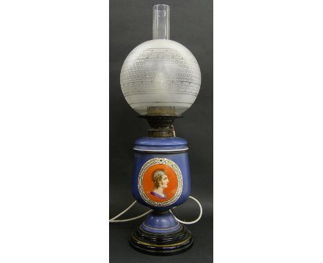 Early 20th century converted porcelain oil lamp with etched globe shade and flue, the porcelain body painted with portraits o
