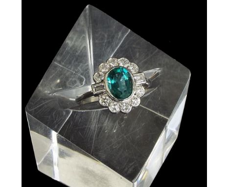 18ct white gold oval emerald and diamond cluster ring, the emerald 1.20ct approx, within a surround of mixed-cut diamonds, 0.