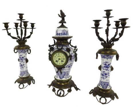 French blue and white porcelain and gilt metal cased two train mantel clock garniture, the movement with outside countwheel s