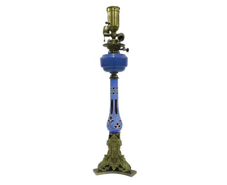 Decorative glass and ormolu oil lamp converted to electricity, the blue overlaid baluster glass column over a triform ormolu 