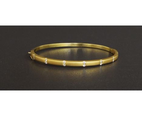 14ct yellow gold diamond set hinged bangle, with fourteen round brilliant cut diamonds, 0.30ct approx, colour G, SI, 17.8gm