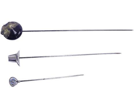 Three silver hat pins one with a hat finial, the other in the manner of Charles Horner with enamel and the other with French 