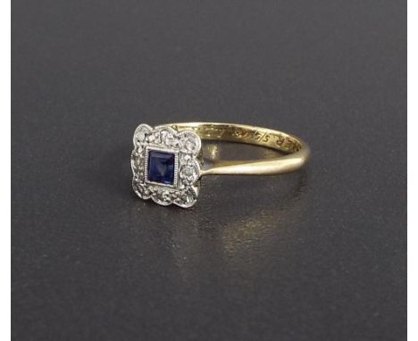 Platinum and 9ct sapphire and diamond square cluster ring, the central princess cut sapphire within a surround of eight round