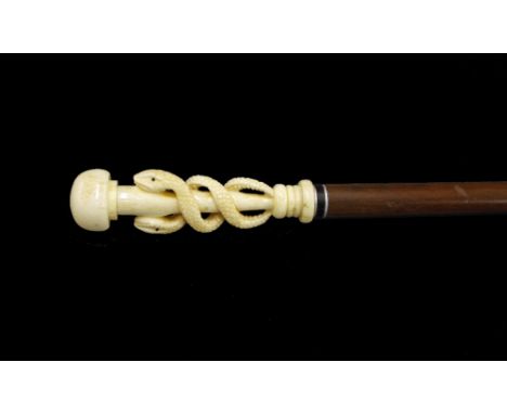 Malacca cane walking stick, the bone handle carved with intertwined coiled serpents, 37" long