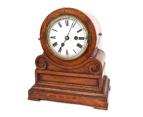 English oak single fusee drumhead mantel clock, the 4.75" white dial within a scrolling panelled stepped case, 12" high (pend