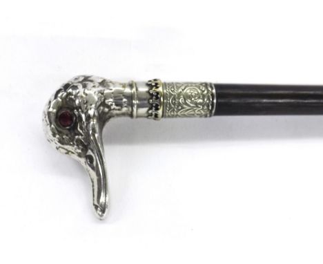 Lady's ebonised walking cane  with white metal knop in the form of a duck's head with ruby type gem set eyes and further whit