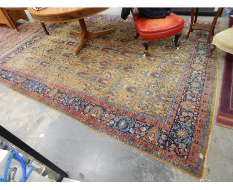 A Persian rug yellow ground floral design to centre, with red and blue borders, 260cm x 350cm 