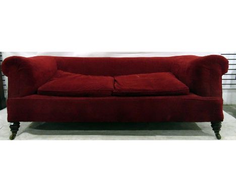 Chesterfield sofa upholstered in red fabric, on short turned supports 