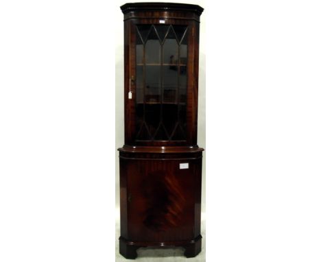 Georgian style mahogany bowfront corner cupboard, the upper section with dentil frieze, the astragal-glazed door enclosing sh