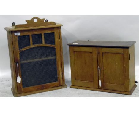 Old pine wall cupboard with glazed door enclosing shelf, 56cm high and another pine wall cupboard with a pair of panelled doo