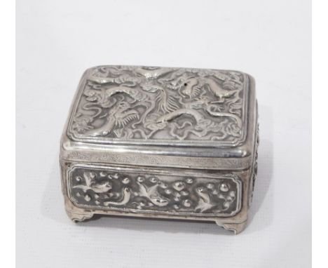 Chinese silver lidded box decorated with repousse decoration of a dragon, decorated to the sides with fish and crabs, on brac