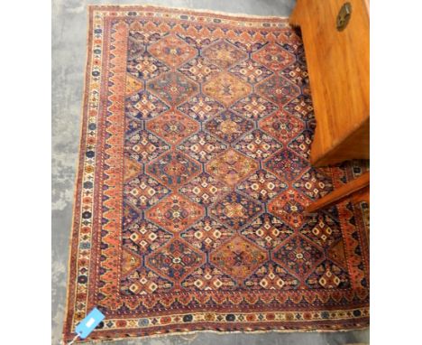 A Persian medallion design rug in blue and red, with cream border, 180cm x 190cm 