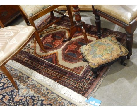 Baluchi wool rug having two octagonal guls, on an ivory field and four geometric borders, 120cm x 87cm 