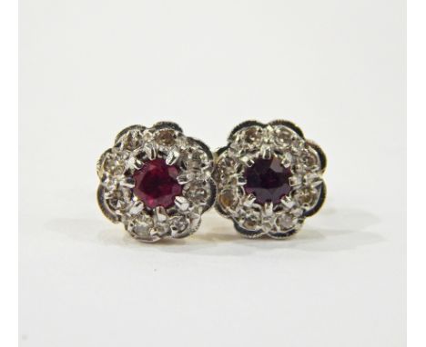 Pair of 18ct gold, ruby and diamond flower-shaped earrings, the centre ruby 4mm diameter, surrounded by eight small diamonds,