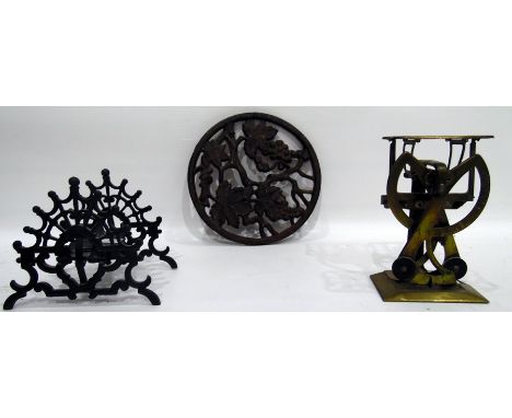 Pair of brass balance letter scales, a folding pierced iron pen rack and an iron trivet, fruiting vine decorated (3) 