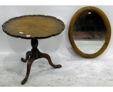 Burr oak piecrust circular top tripod table on turned supports with splayed legs, diameter 61cm together with an oval wall mi