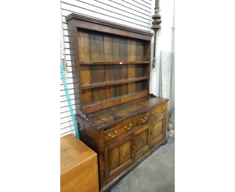 Georgian oak dresser the three tier plate rack with with moulded pediment, reeded uprights, the base with two long and one sh