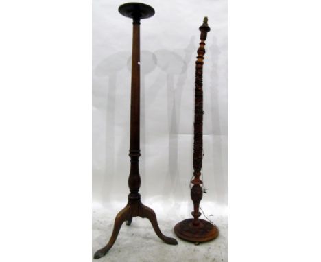 Two foliate carved standard lamp pedestals, on circular bases and a mahogany stand with circular top and splayed tripod legs 