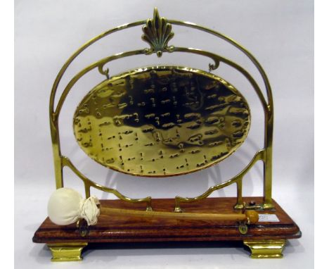 20th century brass table gong with oak rectangular base, on bracket shaped feet, 29cm high approx 