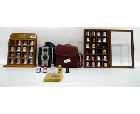 Collection of Kensitas cigarette silks in original cellophane, miniature ceramic thimble collection in wall-mounted frames an