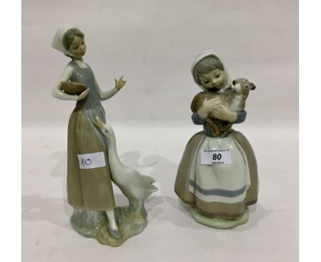Lladro figure of a girl feeding a goose and a Spanish figure of a girl holding a lamb (2) 