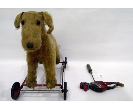 Push-a-long dog on wheels, a wooden toy of a man on a stick and various other games and books 