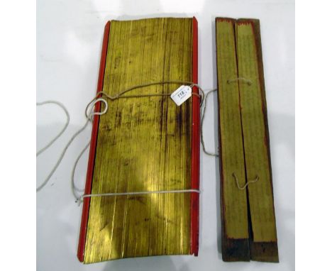 Buddhist Pali manuscript, the text incised on rectangular gilt edged palm leaves and contained between two red lacquered sand