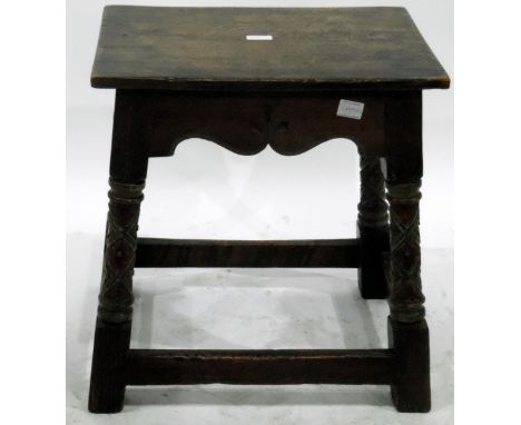 Late 19th century oak joint stool in revived Medieval style, having shaped and carved apron, turned and carved supports with 