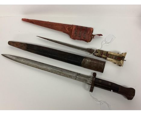 A WW1 British infantry bayonet and scabbard Broad Arrow, War Department Stamp (43cm) together with an Afghan style dagger wit