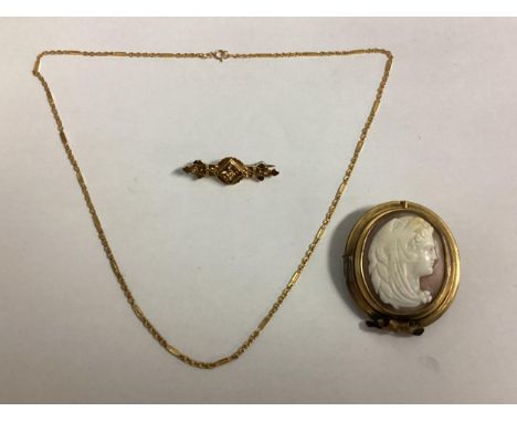 A 15 ct gold Etruscan style bar brooch, together with an 14k gold marked necklace and a yellow metal mounted shell camel broo